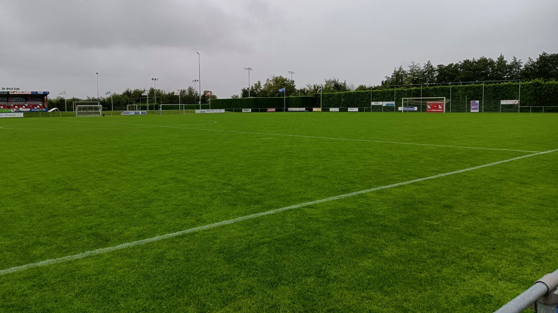 Strak gemaaid voetbalveld dat frequent met Bigmow wordt onderhouden